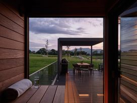 An outdoor patio with a table, chairs, and grass at Wansfell in Penrith