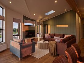 A living room with sofa and coffee table at Wansfell in Penrith