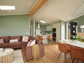 A living room with a sofa and dining table at Wansfell in Penrith