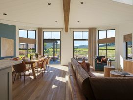 A living room with a sofa and dining area at Wansfell in Penrith