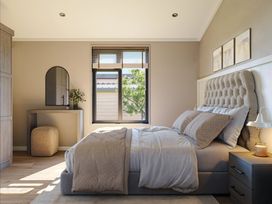 A bedroom with a bed and a mirror at Fell Side in Penrith