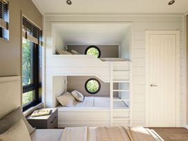 A bedroom with a bunk bed and a window at Fell Side in Penrith