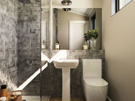 A bathroom with a shower, sink, and toilet at Fell Side in Penrith