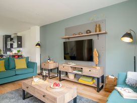 A living room with a sofa and television at Patterdale (Pet) in Penrith
