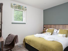 A bedroom with a double bed and a bedside table at Patterdale (Pet) Penrith