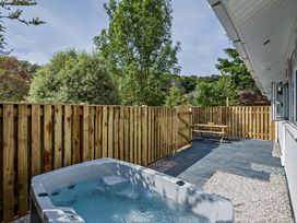 An outdoor area with a hot tub and a table at Klys 1.0 Spa in Perranporth