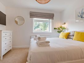 A bedroom with a bed and dresser at Klys 1.0 Spa in Perranporth