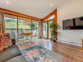 A living room with a sofa and dining table at Piran Spa Lodge Pet Perranporth