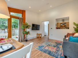 A living room with a table and sofa at Piran Spa Lodge Pet in Perranporth