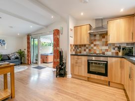 A kitchen with appliances and a hot tub at Chapel Rock Spa Pet Perranporth