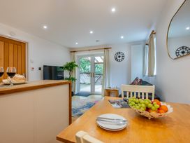 A kitchen with a table and chairs at Poldark Spa Pet, Perranporth