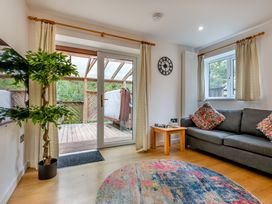 A living room with a sofa and potted plant at Poldark Spa Pet in Perranporth