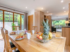 A dining area with a table and fruit bowl at Treehouse Spa in Perranporth