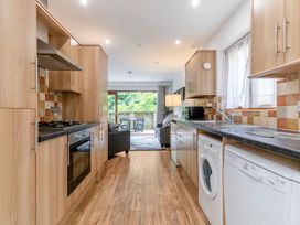 A kitchen with appliances and a dining area at Treehouse Spa in Perranporth