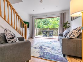 A living room with a sofa and television at Treehouse Spa in Perranporth