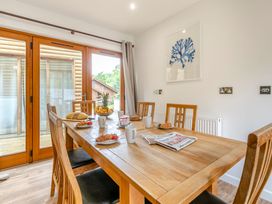 A dining room with a table and chairs at Treehouse Spa in Perranporth