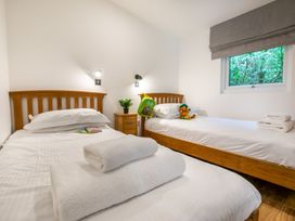 A bedroom with two beds and a nightstand at Morva Spa Pet in Perranporth