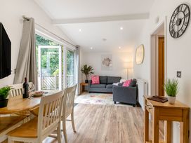 A living room with a dining table and sofa at Morva Spa Pet Perranporth