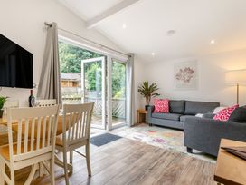 A living room with a sofa and dining area at Morva Spa Pet Perranporth