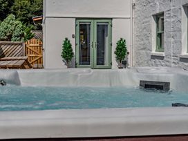 A hot tub and outdoor furniture at The Farmhouse (Pet) Perranporth