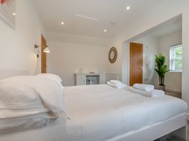 A bedroom with a bed and desk at The Farmhouse (Pet) Perranporth