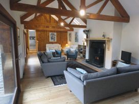 A living room with sofas and a fireplace at Nethercote Byre Minehead