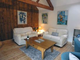 A living room with a sofa and coffee table at Nethercote Byre Minehead