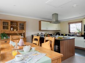 A kitchen with a table and chairs at The Derwent (Pet) in Slaley