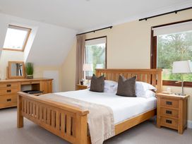 A bedroom with a wooden bed and nightstands at The Derwent (Pet) in Slaley