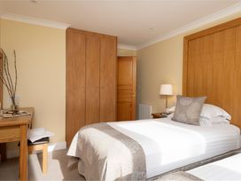 A bedroom with two beds and a table at The Hexham (Pet) Slaley