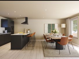 A kitchen with bar stools and a dining table at Heatherwood (Pet) in Slaley