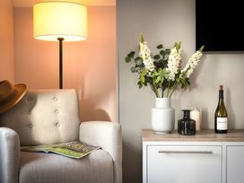 A living room with an armchair and a side table at The Hexham Spa in Slaley