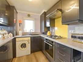A kitchen with a sink and washing machine at Dartmoor View in Exeter