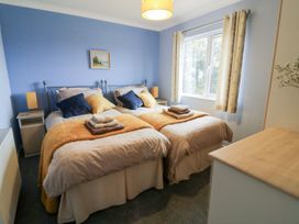 A bedroom with twin beds and a window at Dartmoor View in Exeter
