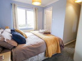 A bedroom with a bed and towels at Dartmoor View in Exeter