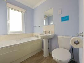 A bathroom with a bathtub, sink, and toilet at Dartmoor View in Exeter