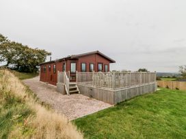 A cabin with a deck and steps at Dartmoor View in Exeter