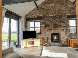 A living room with a fireplace and television at Long Linney in Bideford