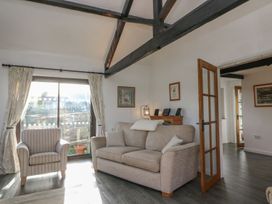 A living room with a sofa and armchair at Long Linney in Bideford