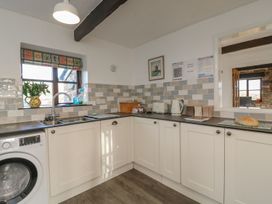 A kitchen with a sink and washing machine at Long Linney in Bideford