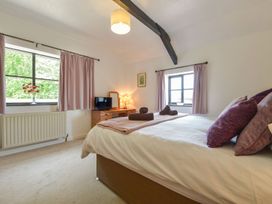 A bedroom with a bed and a TV at Long Linney in Bideford