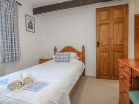 A bedroom with a bed and bedside table at Long Linney in Bideford