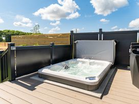 A hot tub on a wooden deck at The Oasis in Great Ayton