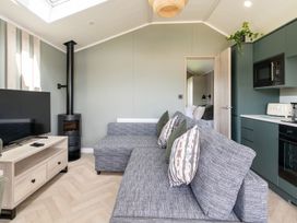 A living room with a sofa and television at The Oasis in Great Ayton