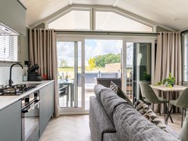 A living room with a kitchen and dining area at The Oasis in Great Ayton