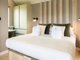 A bedroom with a bed and wardrobe at The Oasis in Great Ayton