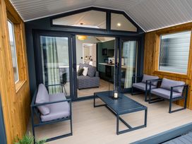 An outdoor area with seating and a view of the living room at The Oasis in Great Ayton