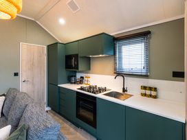 A kitchen with cabinets and appliances at The Oasis in Great Ayton