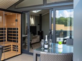 A sauna next to a living area with a table and chairs at The Oasis in Great Ayton