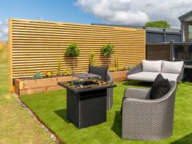A seating area with a table and chairs at The Oasis in Great Ayton